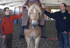 CanAssist's Andy (left) and Mike make several trips to the stables to ensure the Saddle Support is safe and comfortable.