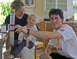 Co-op student Mike, who designed the device, sets it up for Anika and her mom, Ivana.