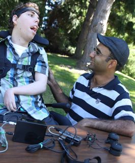 David, left, wears a headband lined with electrodes. This is connected to the EMG box, which is turn is connected to the podWiz.